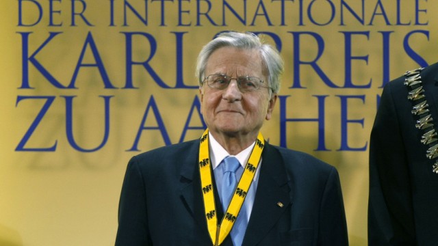 European Central Bank (ECB) President Jean-Claude Trichet smiles after receiving the Charlemagne Prize 2011 in the western German city of Aachen