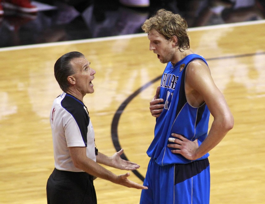Dallas Mavericks' Nowitzki of Germany argues a foul with the referee during the first half in Game 2 of the NBA Finals basketball series against the Miami Heat in Miami