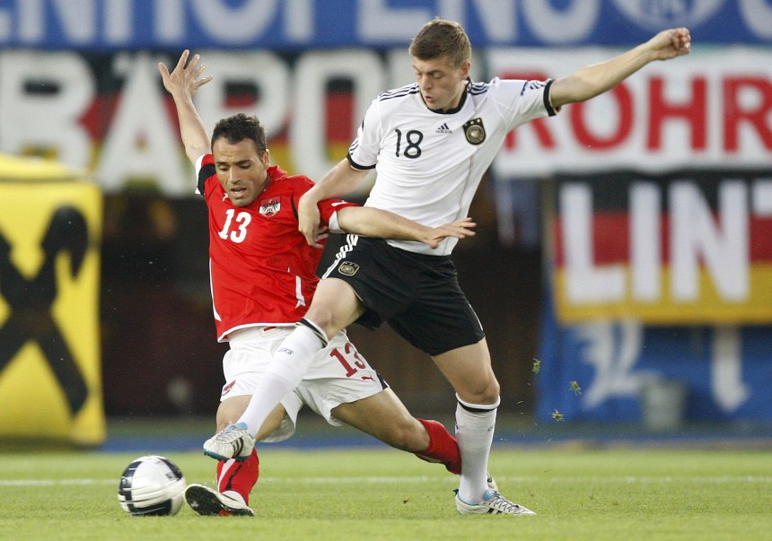 Austria's Dag challenges Germany's Kroos during their Euro 2012 Group A qualifying soccer match at the Ernst Happel stadium in Vienna