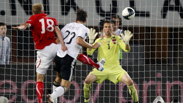 Germany's Gomez scores a goal past Austria's Royer and Gratzei during their Euro 2012 Group A qualifying soccer match in Vienna