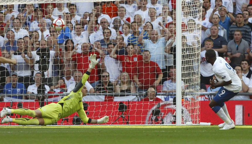 Switzerland's goalkeeper Benaglio dives to catch the ball as England's Bent shoots and fails to score during his team's Euro 2012 Group G qualifying soccer match in London