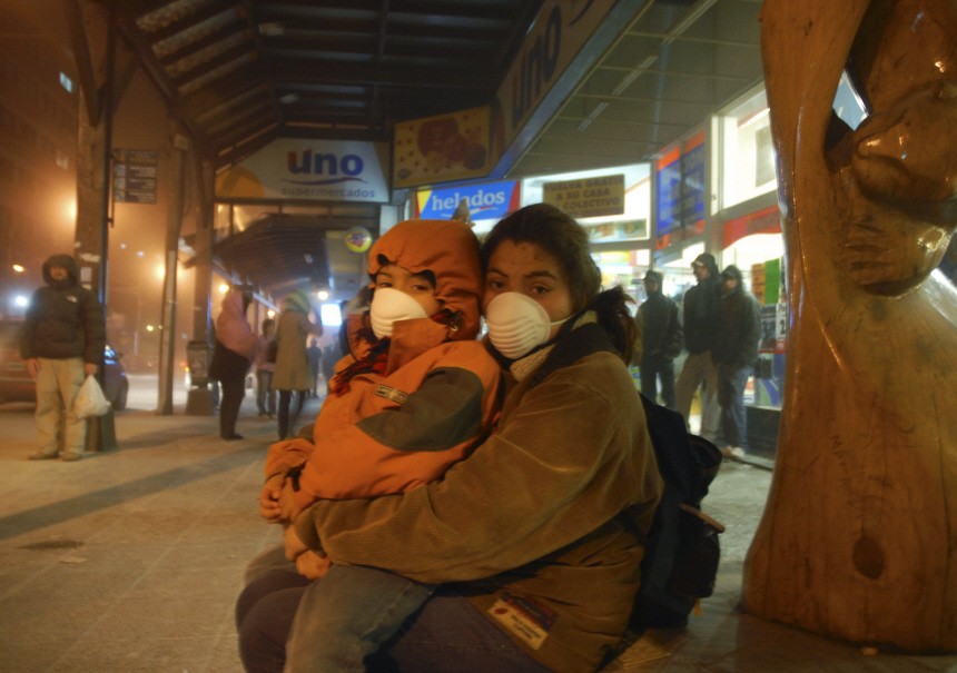 A woman and her child wear protective masks as they take cover from Chile's Puyehue volcanic ash in San Carlos de Bariloche