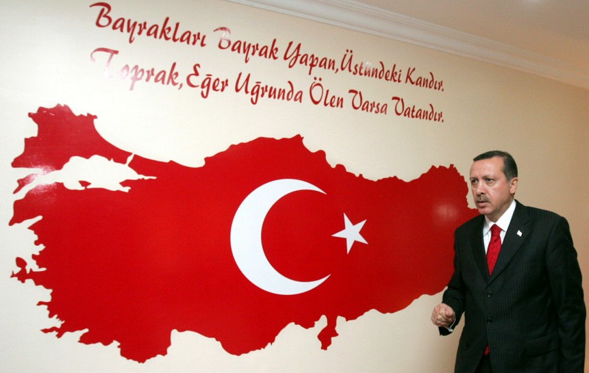 Turkish Prime Minister Tayyip Erdogan stands in front of the map of Turkeyduring visit to Semdinli