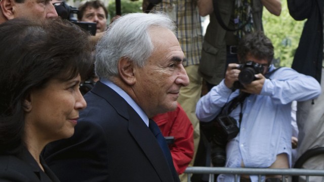 Former IMF chief Dominique Strauss-Kahn departs the New York State Criminal Courthouse with his wife Anne Sinclair after entering a plea of not guilty during a hearing in New York