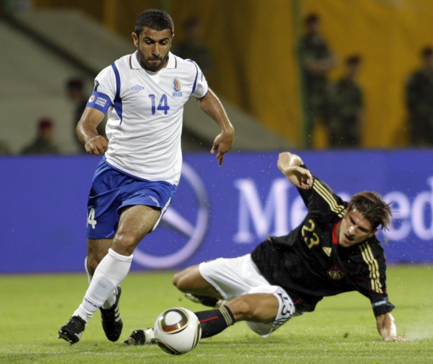 Azerbaijan's Sadygov fights for the ball against Germany's Gomez during their Euro 2012 Group A qualifying soccer match in Baku