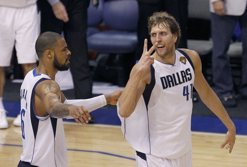 Dallas Mavericks' Nowitzki celebrates with teammate Chandler after scoring a basket against the Miami Heat in the fourth quarter during Game 5 of the NBA Finals basketball series in Dallas