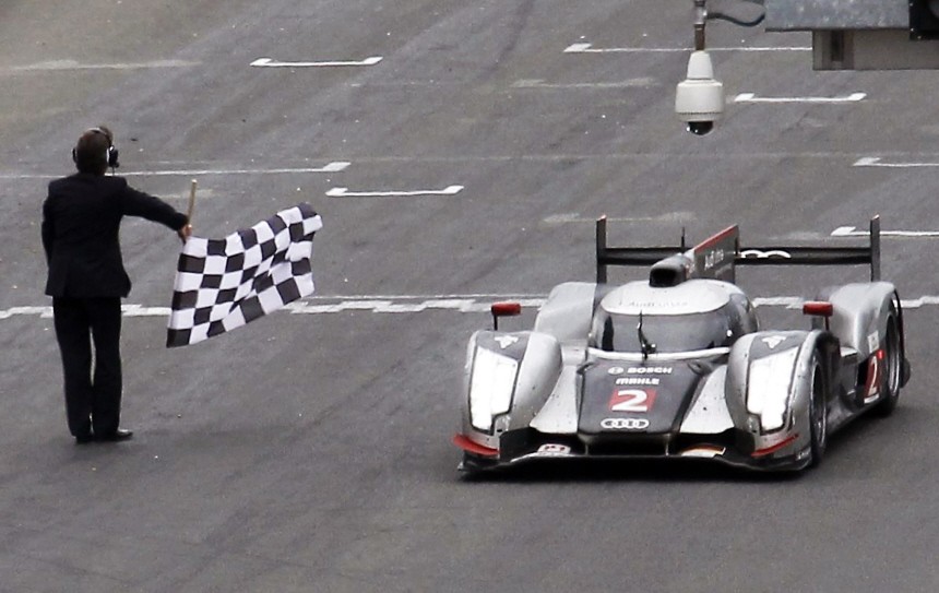 Lotterer of Germany driving the Audi R18 TDI number 2 crosses the finish line at the Le Mans 24-hour sportscar race in Le Mans