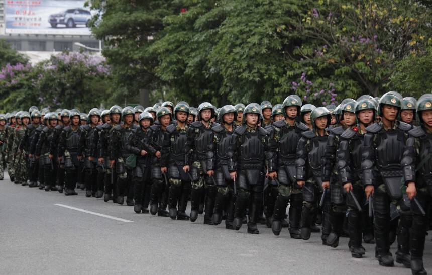 Riot police patrol on a street in the township of Xintang in Zengcheng near the southern Chinese city of Guangzhou
