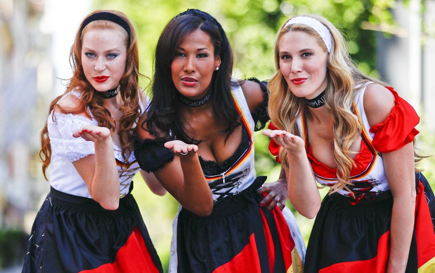 Models pose in a traditional Bavarian dress designed as so-called 'World Cup' dirndl in Munich