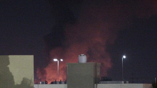 Smoke and fire are seen after coalition air strikes, in Tripoli