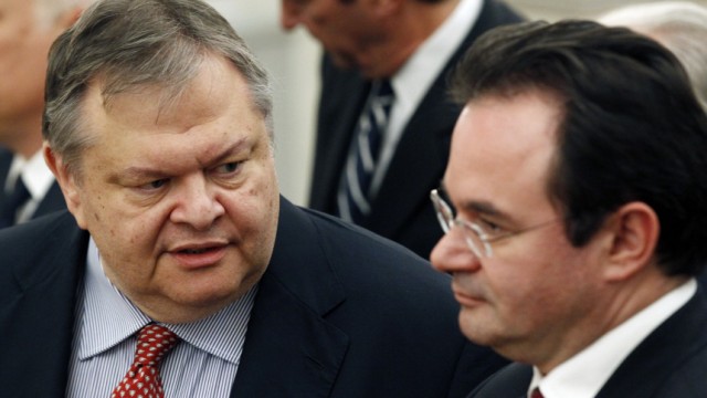 Evangelos Venizelos talks to George Papaconstantinou during a swearing-in ceremony in Athens