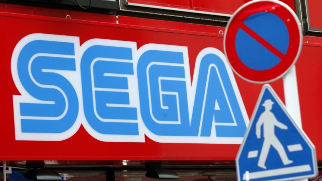A Sega Corp signboard is seen behind traffic signs at the Akihabara electronic store district in Tokyo