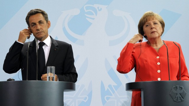 French President Sarkozy and German Chancellor Merkel address a news conference at the Chancellery in Berlin