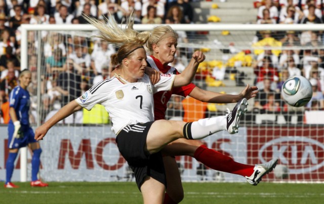 Behringer of Germany challenges Kyle of Canada during their Women's World Cup Group A soccer match in Berlin