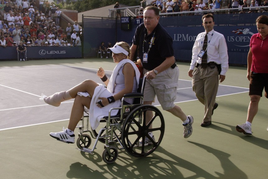 Lisicki is wheeled off the court after falling on match point against Rodionova at the U.S. Open tennis tournament in New York