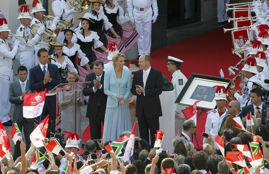 Newlyweds Prince Albert II of Monaco and Princess Charlene applaud on the Palace square after their civil wedding service in Monaco