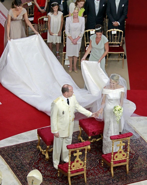 Monaco's Prince Albert II takes the hand of Princess Charlene during their religious wedding ceremony at the Palace in Monaco