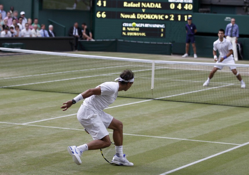 Rafael Nadal of Spain hits a return to Novak Djokovic of Serbia during their men's singles final match against at the Wimbledon tennis championships in London
