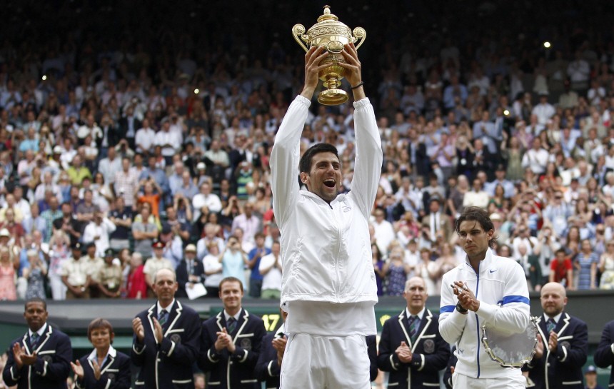 Novak Djokovic of Serbia holds the winners trophy after defeating Rafael Nadal of Spain in the men's singles final at the Wimbledon tennis championships in London