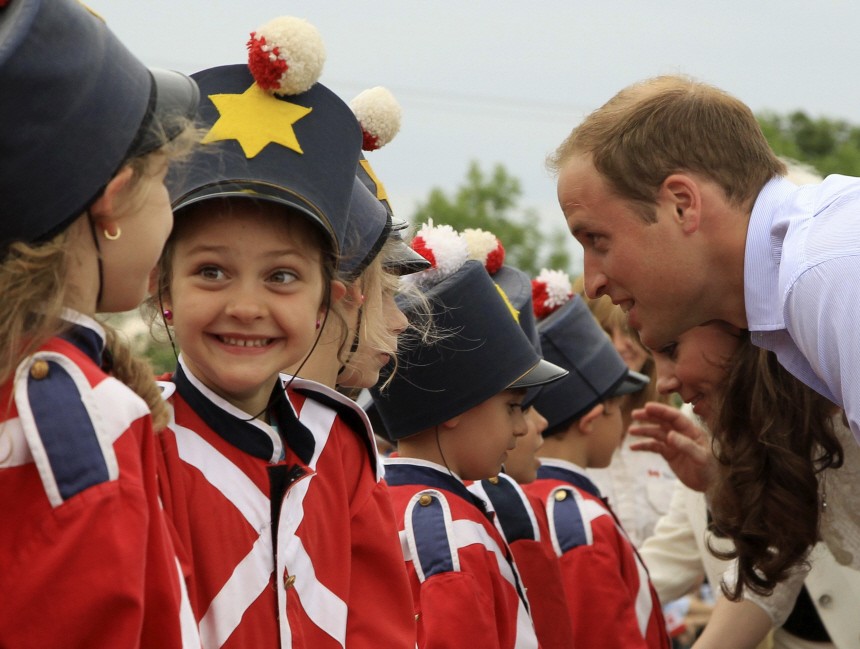 A girl reacts as Britain's Prince William and his wife Catherine, Duchess of Cambridge, greet children at Fort Levis in Levis