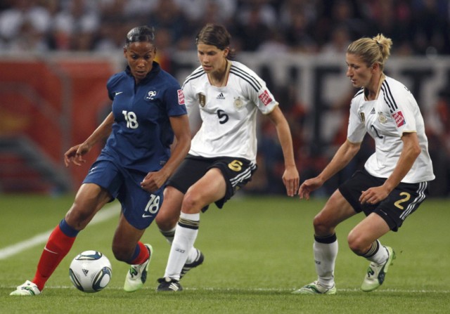 France's Delie tries to pass beside Germany's Krahn and Schmidt during their Women's World Cup Group A soccer match in Monchengladbach