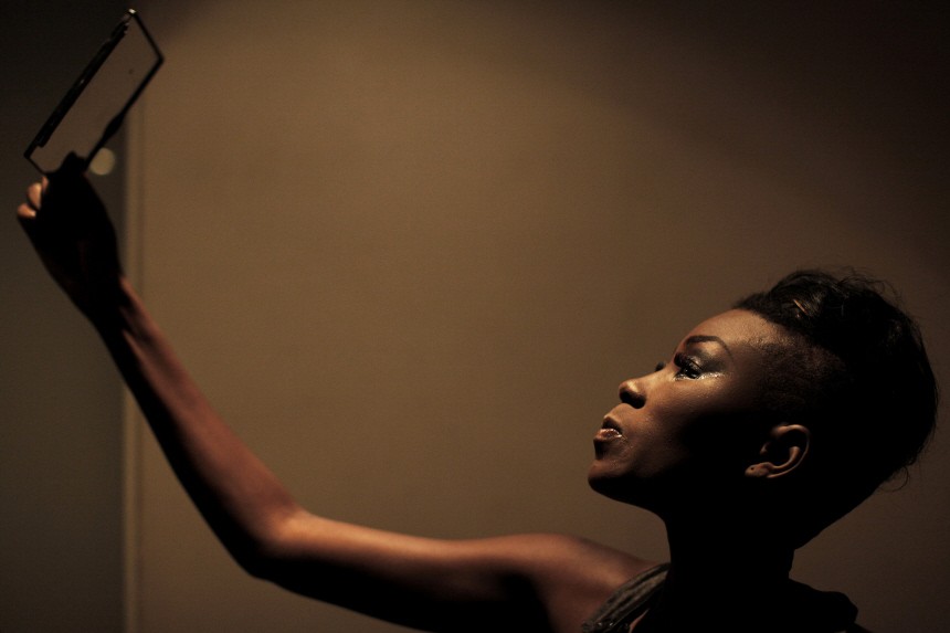 A model checks her make-up backstage during Dakar Fashion Week