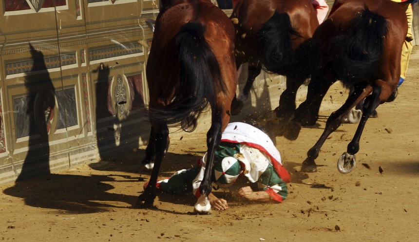 A jockey falls from his horse during a trial race at Del Campo square in Siena