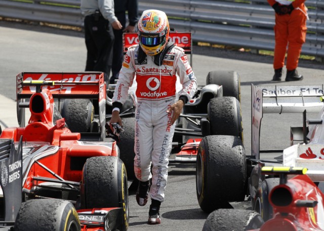 McLaren Formula One driver Lewis Hamilton of Britain leaves his car after the British F1 Grand Prix at Silverstone