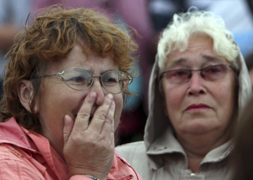 A woman reacts as she meets survivors from the Bulgaria tourist boat, which sank on the Volga river, at the port of Kazan