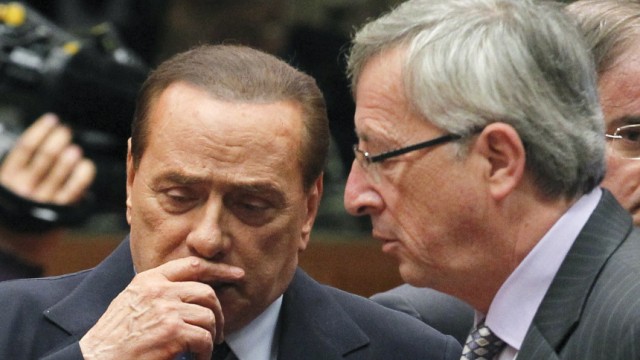 Italy's Prime Minister Berlusconi talks with Luxembourg's Juncker at the start of an EU leaders summit in Brussels
