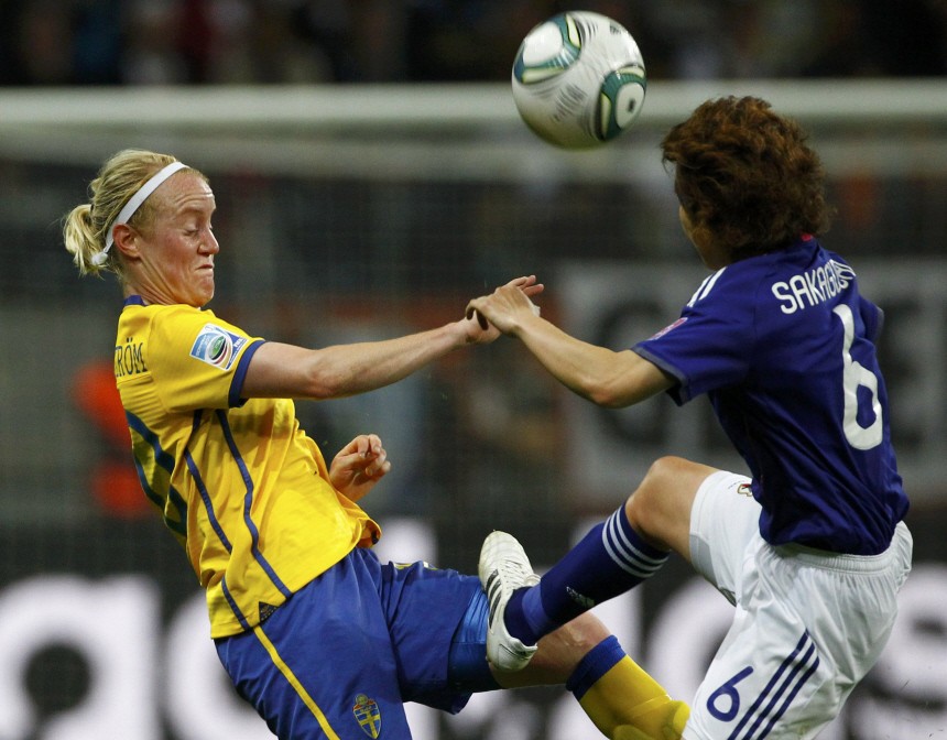 Hammarstrom of Sweden fights for the ball with Sakaguchi of Japan during their Women's World Cup semi-final soccer match in Frankfurt