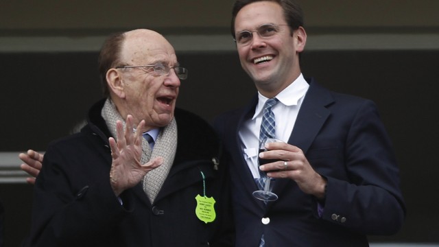 File photo of News Corp Chief Executive Rupert Murdoch talking to his son James Murdoch in Gloucestershire