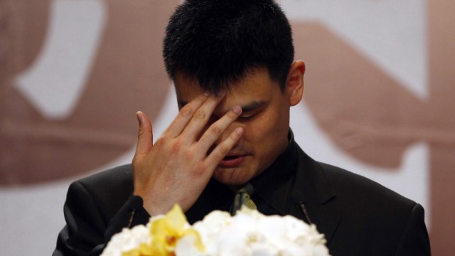 NBA player Yao Ming reacts during a news conference to announce his retirement from basketball, in Shanghai