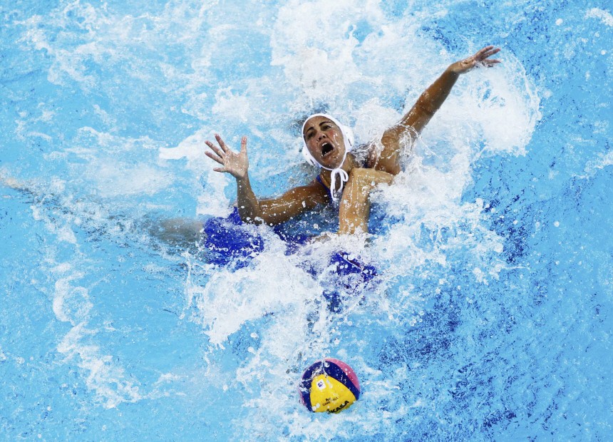 Canetti of Brazil fights for the with Belyaeva of Russia during their preliminary round women?s water polo match at the 14th FINA World Championships in Shanghai