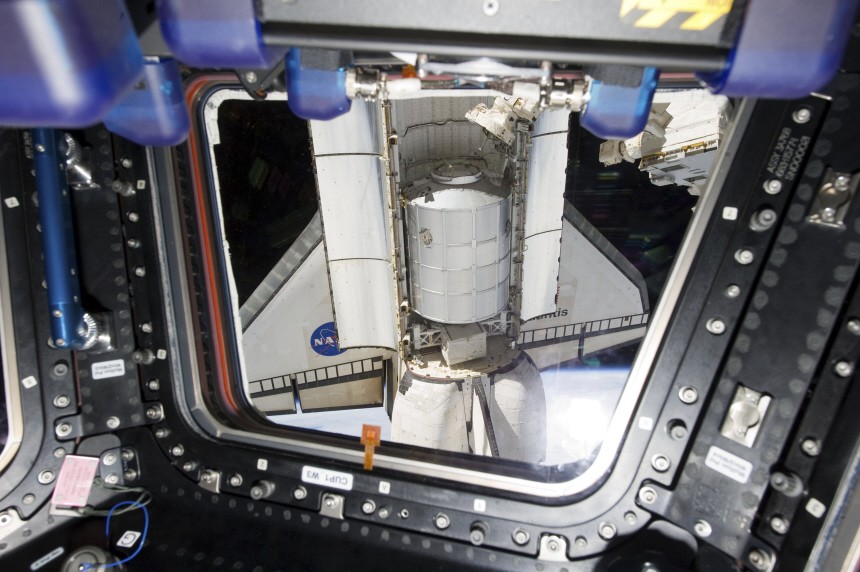 NASA handout photo shows space shuttle Atlantis still docked with the International Space Station in this view through a window of the station's cupola