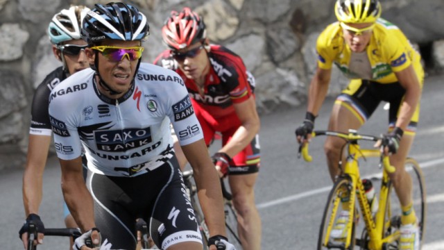 Saxo Bank rider Alberto Contador of Spain rides in front of Leopard Trek's Andy Schlek during the 19th stage of the Tour de France 2011 cycling race from Modane to Alpe d'Huez