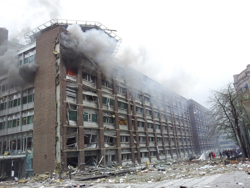Smoke billows from a 17-storey government building after a powerful explosion rocked central Oslo