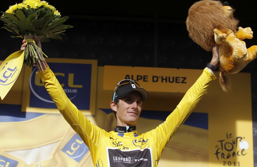 Leopard-Trek's Andy Schleck of Luxembourg celebrates wearing the leader's yellow jersey on the podium after the 19th stage of the Tour de France 2011 cycling race from Modane to Alpe d' Huez
