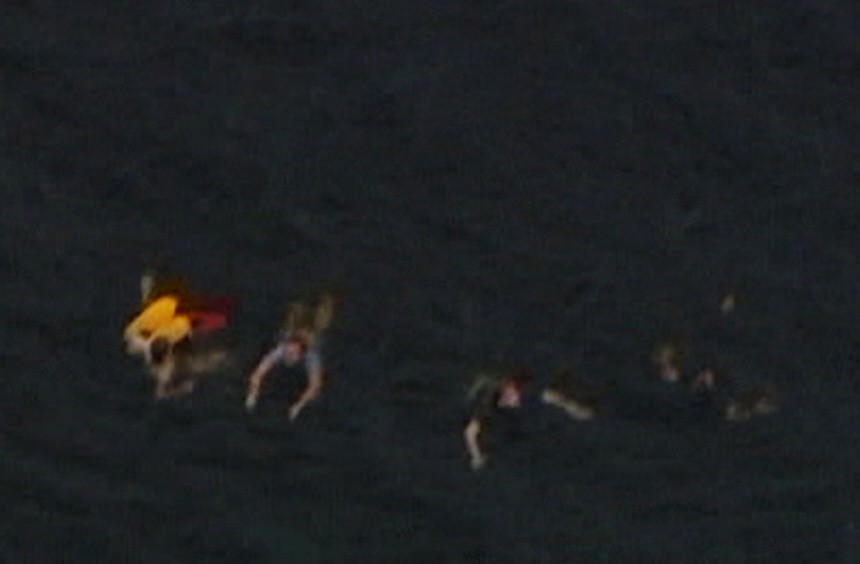 Aerial view shows people swimming in the water near Utoeya island after shooting
