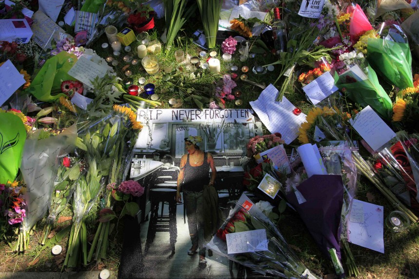 Flowers and tributes are seen outside the home of Amy Winehouse in London