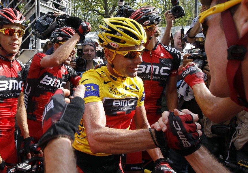 BMC Racing Team's Evans of Australia celebrates with his teammates after crosses the finish line in Paris during the final stage of the 98th Tour de France cycling race