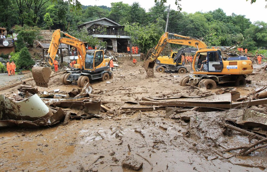 Rescue workers search for possible survivors among collapsed houses in Chuncheon