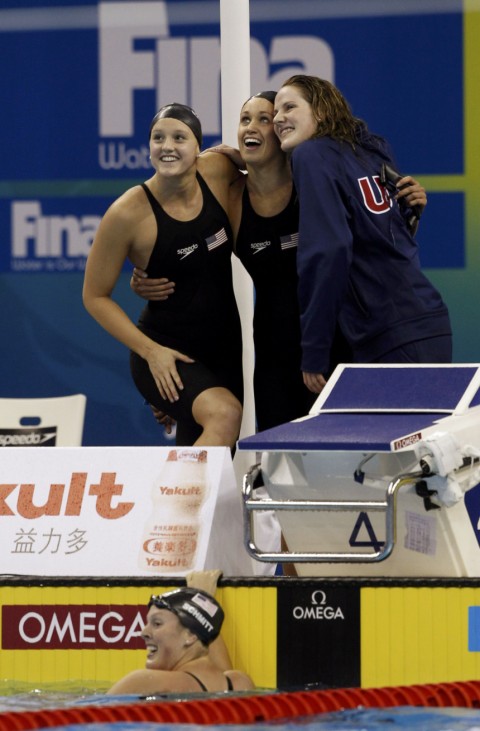 Tosky, Hoff and Franklin of U.S. celebrate their first place in women's 4 X 200m freestyle final as their teammate Knutson smiles while still in pool at 14th FINA World Championships in Shanghai