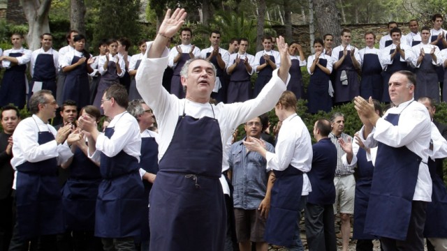 Ferran Adria, chef and co-owner of El Bulli restaurant, gestures during a photo opportunity with his team in Cala Montjoi, near Roses