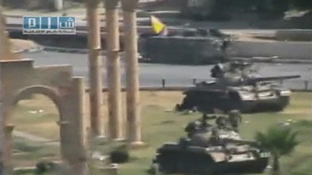 Armoured vehicles are seen stationed in the city of Hama in this still image taken from video posted on a social media website