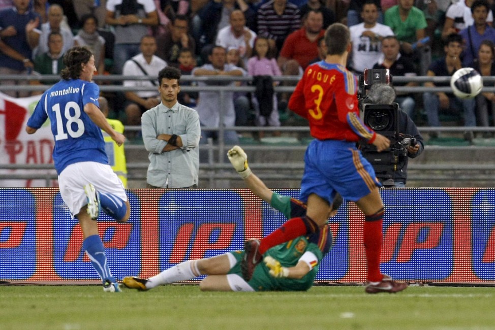 Italy's Montolivo shoots to score past Spain's goalkeeper Casillas during their international friendly soccer match at the San Nicola stadium in Bari