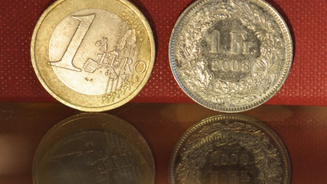 Euro-Münze und Schweizer Franken