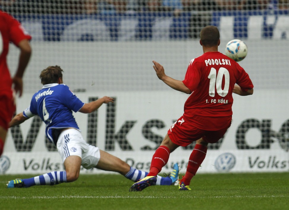 Cologne's Podolski scores a goal against Schalke 04 during their German first division Bundesliga soccer match in Gelsenkirchen