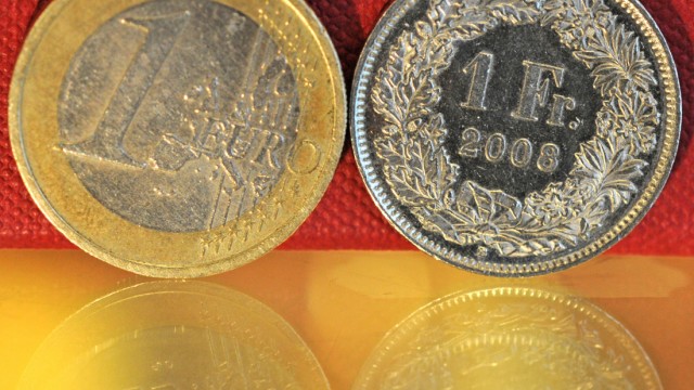 Euro-Münze und Schweizer Franken