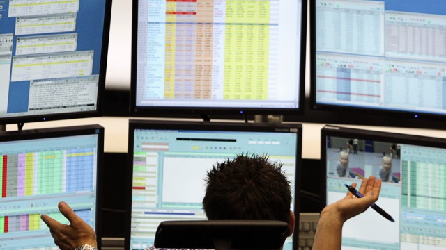 Trader reacts at his desk at the Frankfurt stock exchange